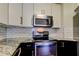 Bright kitchen features stainless steel appliances, granite counters, and subway tile backsplash at 1858 Michigan Ne Ave, St Petersburg, FL 33703