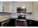 Modern kitchen features stainless steel appliances, granite counters, and white subway tile backsplash at 1858 Michigan Ne Ave, St Petersburg, FL 33703
