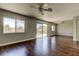 Bright living room with hardwood floors, ceiling fan, and sliding glass door to a wood deck at 1858 Michigan Ne Ave, St Petersburg, FL 33703