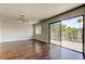 Open living room with wood floors, ceiling fan, and deck access through sliding glass door at 1858 Michigan Ne Ave, St Petersburg, FL 33703