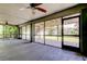 View of the spacious screened in porch with concrete flooring and ceiling fans, overlooks the backyard at 1858 Michigan Ne Ave, St Petersburg, FL 33703