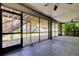 Screened-in porch features concrete flooring and a view of the backyard and the staircase at 1858 Michigan Ne Ave, St Petersburg, FL 33703