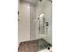 Modern shower with glass door, unique tile accent, and hexagon tile flooring at 1858 Michigan Ne Ave, St Petersburg, FL 33703