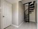 Unique interior view highlighting a spiral staircase adjacent to a white entry door at 1858 Michigan Ne Ave, St Petersburg, FL 33703