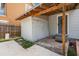 Back entrance with a small storage unit, steps to the door, and an overhanging roof at 1902 N Tampania Ave, Tampa, FL 33607