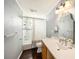 Clean bathroom featuring an over-sized vanity and a shower/tub combination with a white shower curtain at 1902 N Tampania Ave, Tampa, FL 33607