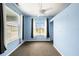 Bright bedroom with a ceiling fan and two large windows offering plenty of natural light at 1902 N Tampania Ave, Tampa, FL 33607