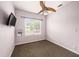Comfortable bedroom featuring a ceiling fan and a window overlooking the outside, as well as wall mounted TV at 1902 N Tampania Ave, Tampa, FL 33607