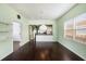 Bright dining room with hardwood floors, light green walls, and modern lighting fixture at 1902 N Tampania Ave, Tampa, FL 33607