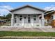 Charming single-story home with a welcoming front porch and a well-maintained lawn at 1902 N Tampania Ave, Tampa, FL 33607