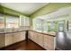 The spacious kitchen features light wood cabinets, stone countertops, and modern appliances at 1902 N Tampania Ave, Tampa, FL 33607