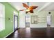 Hardwood floors, an ornate ceiling fan, and natural light welcome you to this beautiful living area at 1902 N Tampania Ave, Tampa, FL 33607