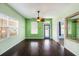 Open-concept living area features hardwood floors, ample natural light, and a contemporary ceiling fan at 1902 N Tampania Ave, Tampa, FL 33607