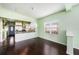 Inviting living room featuring wood flooring, a hanging light fixture and a view of the kitchen at 1902 N Tampania Ave, Tampa, FL 33607