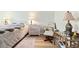 Cozy bedroom with a comfortable chair, dresser, and decorative lamps at 19029 Us Highway 19 N # 3-1, Clearwater, FL 33764