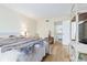 Bright bedroom with a view into the bathroom, comfortable bed, and storage at 19029 Us Highway 19 N # 3-1, Clearwater, FL 33764