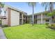 Charming condo complex with well-maintained lawn and beautiful palm trees at 19029 Us Highway 19 N # 3-1, Clearwater, FL 33764