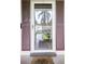 Inviting entryway with a storm door and charming brown shutters at 19029 Us Highway 19 N # 3-1, Clearwater, FL 33764