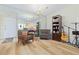 Comfortable living room area featuring a bookshelf and a large mirror wall at 19029 Us Highway 19 N # 3-1, Clearwater, FL 33764