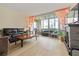 Inviting living room with a fireplace and a seamless transition to the sunroom at 19029 Us Highway 19 N # 3-1, Clearwater, FL 33764