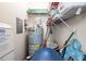 Storage area with a water heater, shelves, and various household items, offering practical storage solutions at 19029 Us Highway 19 N # 3-1, Clearwater, FL 33764