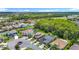 Picturesque aerial view of a residential area with lush greenery and a winding lake nearby at 1958 Marshberry Ct, Trinity, FL 34655