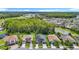 Scenic aerial view of a residential neighborhood near a lush green forest and small lake at 1958 Marshberry Ct, Trinity, FL 34655