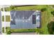 Overhead view of house featuring a swimming pool, screened in patio and solar panels at 1958 Marshberry Ct, Trinity, FL 34655