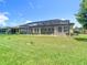 Spacious backyard featuring a screened-in patio, ideal for outdoor entertaining at 1958 Marshberry Ct, Trinity, FL 34655