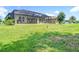 Expansive backyard with screened-in lanai, offering ample space for recreation at 1958 Marshberry Ct, Trinity, FL 34655