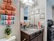 Beautiful bathroom vanity with granite countertop, decorative towels, and framed artwork above the sink at 1958 Marshberry Ct, Trinity, FL 34655