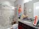 Well-appointed bathroom featuring a glass shower enclosure and granite vanity at 1958 Marshberry Ct, Trinity, FL 34655