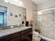 Bathroom featuring a granite vanity, walk-in shower, and neutral colored tile at 1958 Marshberry Ct, Trinity, FL 34655