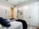 Bedroom featuring grey accent wall, neutral decor, wood-look floors, and double door closet at 1958 Marshberry Ct, Trinity, FL 34655