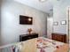 Comfortable bedroom with chandelier, television, and coordinated decor at 1958 Marshberry Ct, Trinity, FL 34655