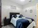 Cozy bedroom with accent wall, wood-look floors, dark wood furniture, and decorative lighting at 1958 Marshberry Ct, Trinity, FL 34655