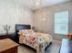 Well-lit bedroom with floral bedding, side tables, and a chandelier above at 1958 Marshberry Ct, Trinity, FL 34655