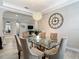 View of the dining room featuring a glass table and a chandelier with neutral decor at 1958 Marshberry Ct, Trinity, FL 34655