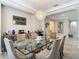Elegant dining room featuring a glass table, chandelier, and stylish decor at 1958 Marshberry Ct, Trinity, FL 34655
