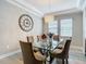 View of the dining room featuring a glass table and a chandelier with neutral decor at 1958 Marshberry Ct, Trinity, FL 34655