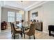 Bright dining room with large windows, glass table, and modern chandelier at 1958 Marshberry Ct, Trinity, FL 34655