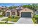 A charming single-Gathering home featuring a well-manicured front yard and a two-car garage at 1958 Marshberry Ct, Trinity, FL 34655