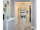 View of the hallway featuring tile flooring, arched doorways, and decorative wall art at 1958 Marshberry Ct, Trinity, FL 34655