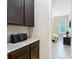 Hallway features cabinets, countertop, and leads to a bedroom in the background at 1958 Marshberry Ct, Trinity, FL 34655