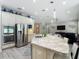 Open-concept kitchen with island, stainless steel appliances, and granite countertops overlooks living space at 1958 Marshberry Ct, Trinity, FL 34655