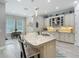 Bright kitchen features a large island with granite countertops, seating, and pendant lighting at 1958 Marshberry Ct, Trinity, FL 34655
