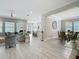 Open-concept floorplan of the living room and dining area with tile flooring and neutral color palette at 1958 Marshberry Ct, Trinity, FL 34655