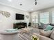 Inviting living room with comfortable seating, modern decor, and large windows at 1958 Marshberry Ct, Trinity, FL 34655