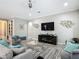 Cozy living room featuring stylish decor, a large TV, and comfortable seating arrangements at 1958 Marshberry Ct, Trinity, FL 34655