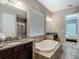 Luxurious bathroom with a garden tub, granite counters, and shower at 1958 Marshberry Ct, Trinity, FL 34655